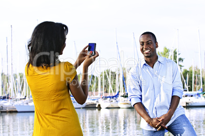 Man posing for picture near boats