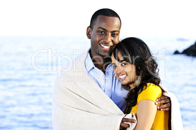 Happy couple sharing blanket