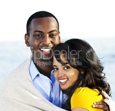 Happy couple sharing blanket