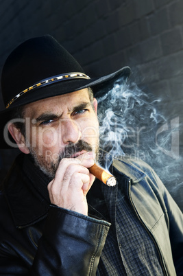 Bearded man smoking cigar