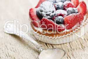 Fruit tart with spoon