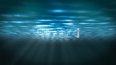 Underwater scene with sunrays shining through the water's surface. (Looping)