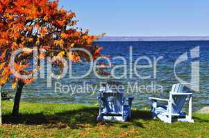 Wooden chairs on autumn lake