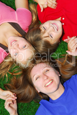 Family lying down on grass