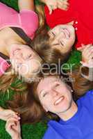 Family lying down on grass