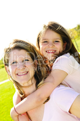 Mother and daughter piggyback