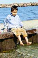 Boy playing on pier