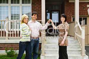 Happy couple with real estate agent