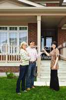 Happy couple with real estate agent