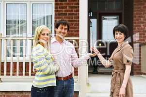 Happy couple with real estate agent