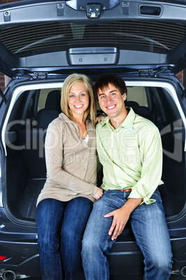 Couple sitting in back of car