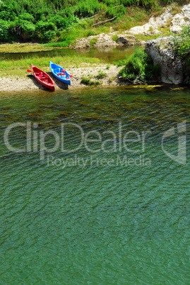 Kayaks on river bank