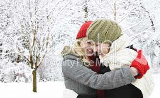 Two girl friends hugging outside in winter
