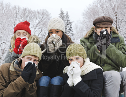 Group of friends with colds outside in winter