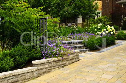 Landscaped  garden and stone paved driveway