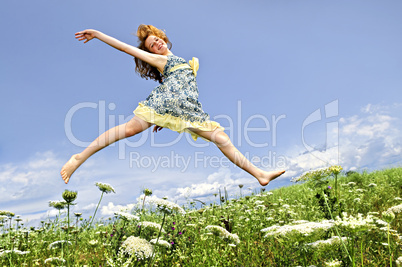 Young girl jumping in meadow