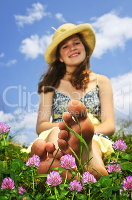 Young girl sitting on meadow