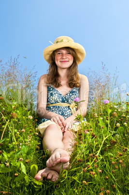 Young girl sitting in meadow