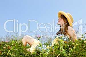 Young girl sitting in meadow