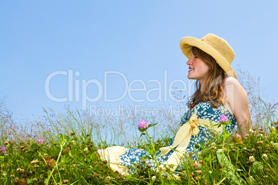 Young girl sitting in meadow