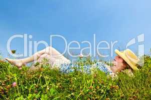 Young girl laying in meadow