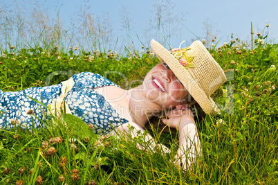 Young girl laying on meadow