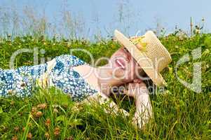 Young girl laying on meadow