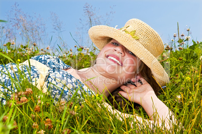 Young girl laying on meadow