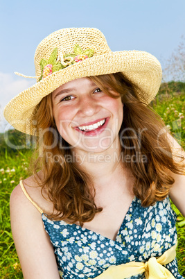 Portrait of young girl smiling in meadow