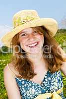 Portrait of young girl smiling in meadow