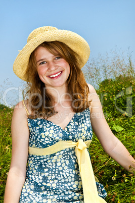 Young girl sitting in meadow