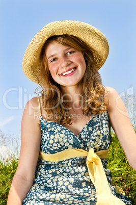 Young girl sitting in meadow