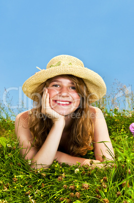 Young girl laying in meadow