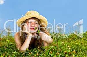 Young girl laying in meadow