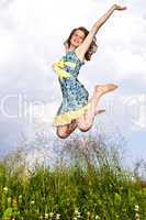 Young girl jumping in meadow