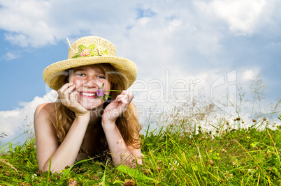 Young girl laying in meadow