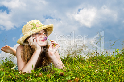 Young girl laying in meadow