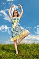Young girl dancing in meadow