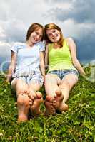Young girls sitting in meadow