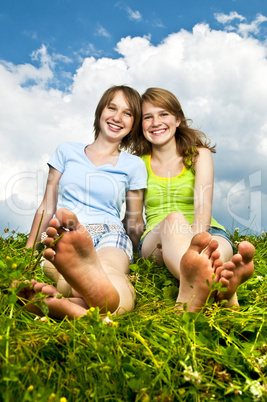 Young girls sitting in meadow