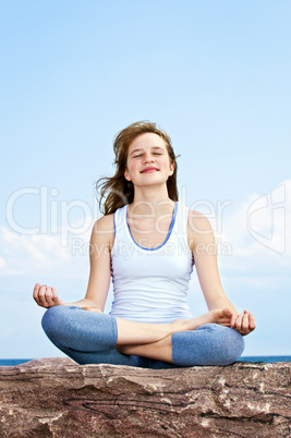 Young girl meditating outdoors