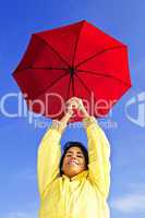 Beautiful young woman in raincoat with umbrella