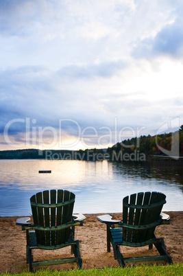 Wooden chairs at sunset on beach