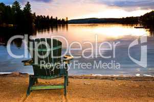 Wooden chair at sunset on beach