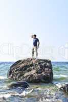 Man stranded on a rock in ocean