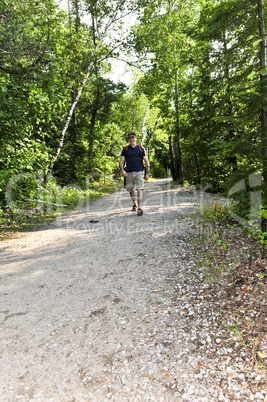 Man walking on forest trail