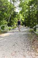 Man walking on forest trail