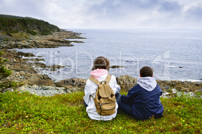 Children sitting at Atlantic coast in Newfoundland