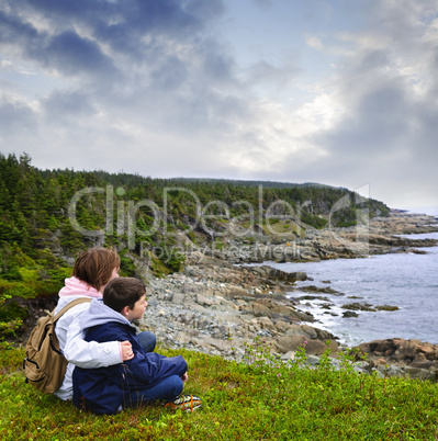 Children sitting at Atlantic coast in Newfoundland