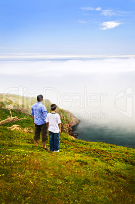 Father and son at ocean coast